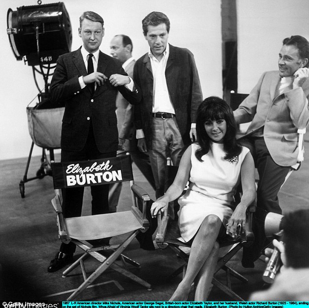 Director Mike Nichols, actor George Segal, Elizabeth Taylor, and her husband, Richard Burton, smiling on the set of Nichols' film, Who's Afraid of Virginia Woolf?