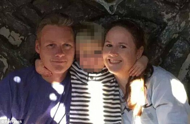 A three-year-old boy has been critically wounded after being shot in his mouth while playing with his four-year-old neighbor. Pictured: Father Jon Holzwarth with a young boy who is believed to be his son Michael