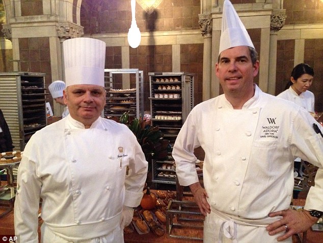 Coupling the haves and have-nots: David Garcelon (right), director of Culinary at the Waldorf-Astoria hotel and Jacques Sorci (left), executive chef at The New York Palace, prepare for the arrival of wealthy New Yorkers eating dinner with homeless people at St Bartholomew's Church on Friday