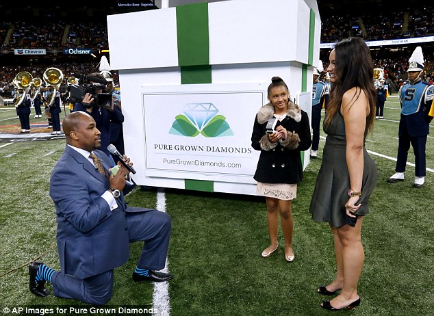 Down on one knee: Mills got out a microphone to propose to his girlfriend in front of 41,000 people