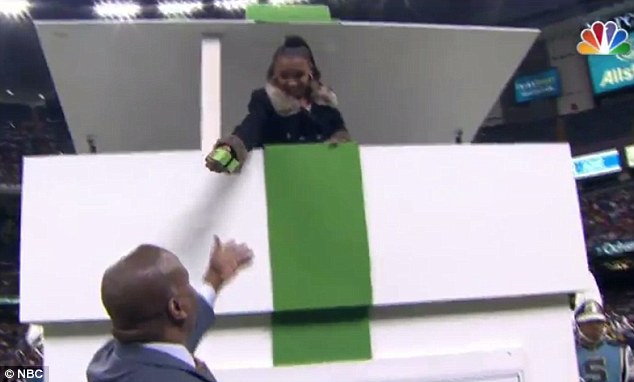 Use it well: Ramsey's daughter, 12-year-old Ajaya, sprung out of a giant gift box to give Mills the ring during the game Saturday