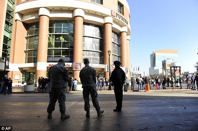 Tensions still high: Police and Missouri National guard stand outside the Edward Jones Dome before the start of Sunday's game between the St. Louis Rams and the Oakland Raiders