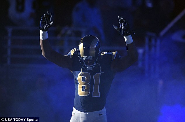 Protest: St. Louis Rams wide receiver Kenny Britt (81) puts his hands up to show support for Michael Brown before a game against the Oakland Raiders at the Edward Jones Dome