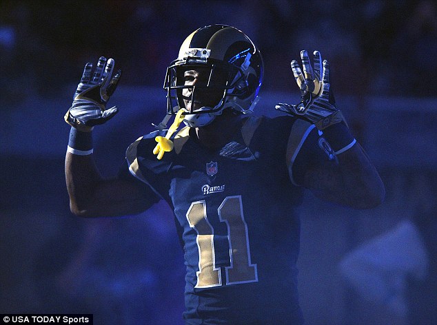Injustice? St. Louis Rams wide receiver Tavon Austin (11) puts his hands up to show support for Michael Brown before a game against the Oakland Raiders