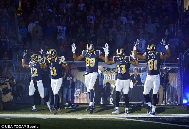 Solidarity: St. Louis Rams wide receiver Stedman Bailey (12), wide receiver Tavon Austin (11), tight end Jared Cook (89), wide receiver Chris Givens (13) and wide receiver Kenny Britt (81) put their hands up to show support for Michael Brown before Sunday's game against the Oakland Raiders at the Edward Jones Dome