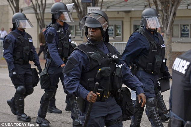 Scouting: About 30 police wearing riot gear watched the protesters from a safe distance outside the Edward Jones Dome