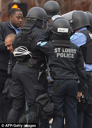 Taken away: One protester is arrested by St. Louis Police outside the stadium on Sunday before the game began