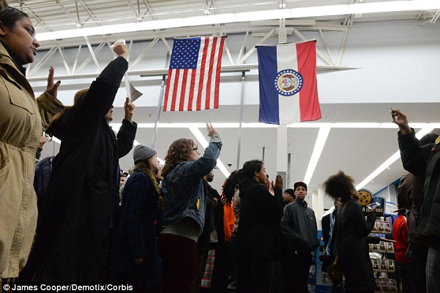What's in store: Protesters inside marched under the flags of Missouri and the United States as they were addressed at a gathering