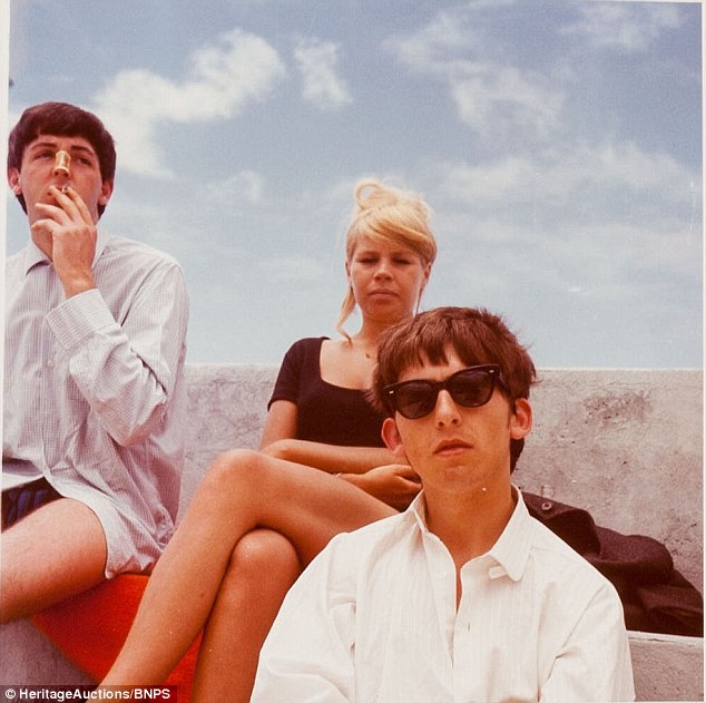 Casually unaware: Paul, 20, sports a plaster on his nose to protect against the harsh sun while photographer Astrid Kirchherr and George look cool for the camera