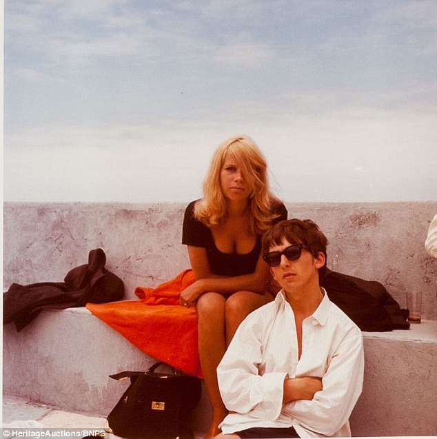 The start of things to come: George strikes a pose behind black wayfarers, as Kirchherr sits behind him