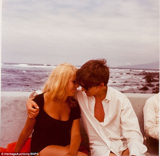 Close: One image shows Kirchherr canoodling with George who wears a dress shirt and swimming shorts