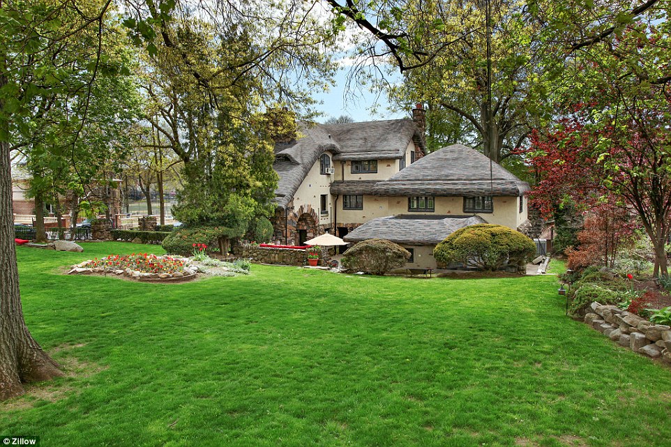 Country chamr: The story-book home sits on a perfectly manicured lawn - perfect for a summer picnic