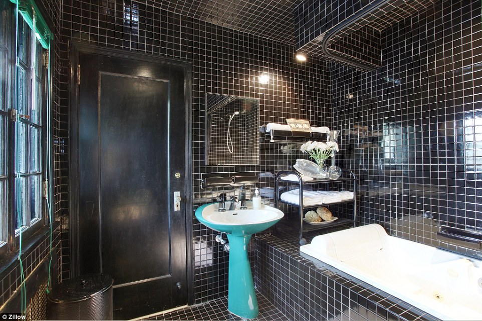 Sleek: Nestled in the wood-paneled, old-school estate is this modern and functional bathroom with a soaking tub