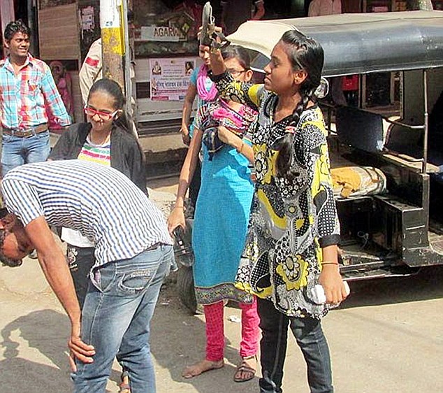 Justice served: One of the teenage girls who accused Virat Dhoni of catcalling her, smack her 23-year-old harrasser with her shoe as her friends are lined up, waiting their turn