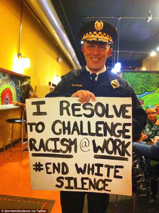 Condemnation: Pittsburgh's new police chief has been criticized by a police union president after being photographed on New Year's Eve holding a sign that said: 'I resolve to challenge racism @ work.'