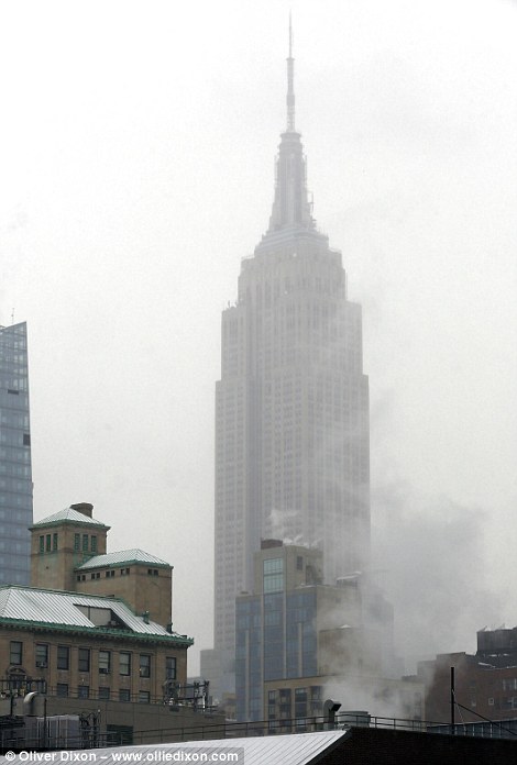 Chilly city: New York was caught off guard Tuesday by a liberal dusting of snow and temperatures that refused to budge past 35F