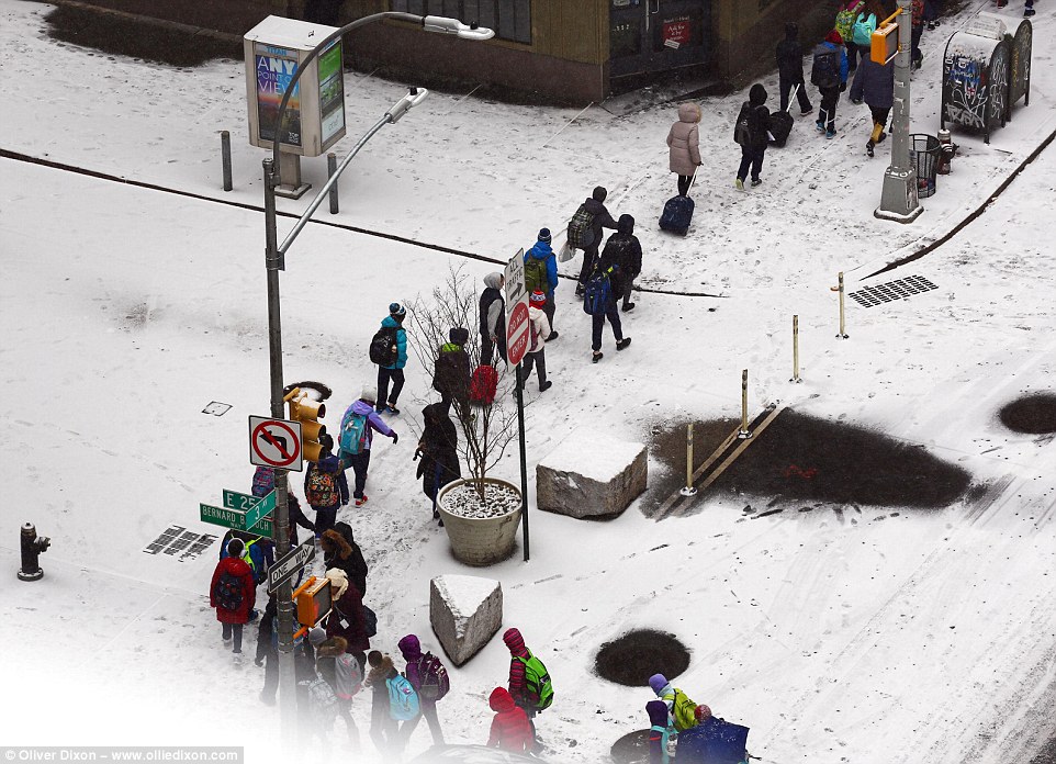 Headache: The snow wasn't enough to cancel school for New York City's students, but traffic and travel plans were snarled for millions across 22 states