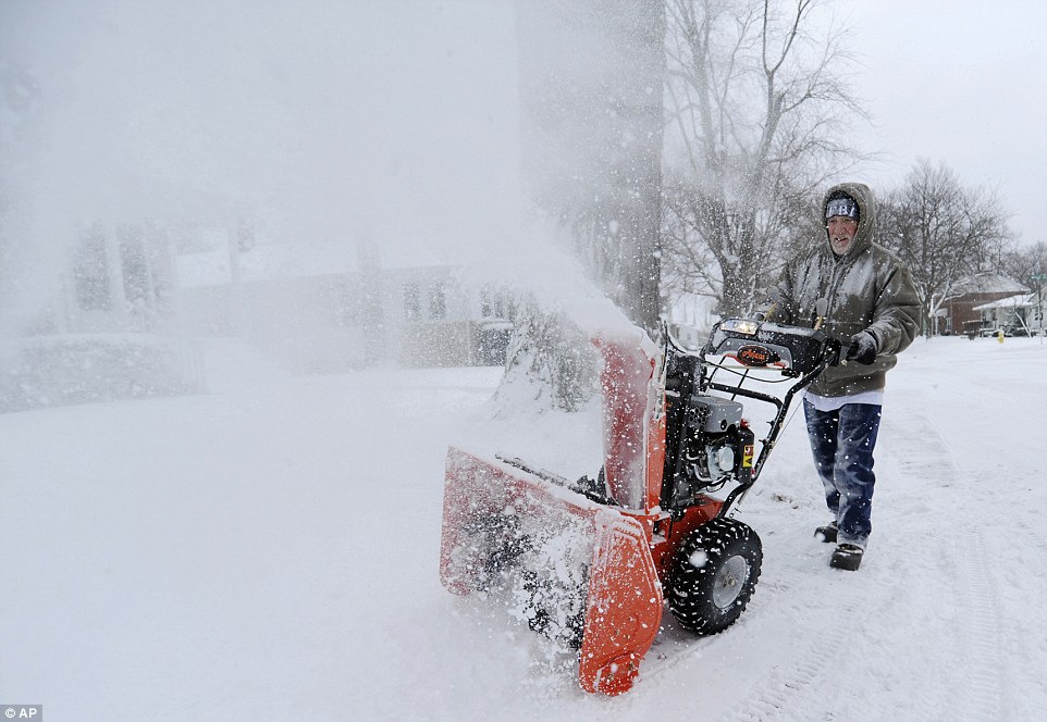 William Bittner tries out his new snowblower as he clears the driveway of his home along Michigan Avenue in St. Joseph, Michigan on Tuesday
