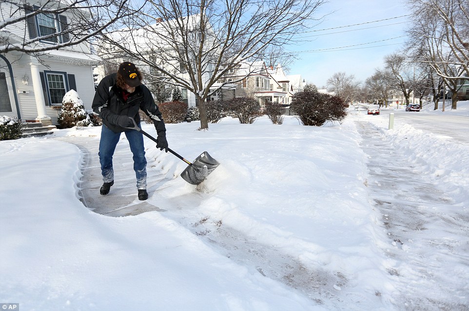 Arnold King shovels his walkway Tuesday, Jan. 6, 2015, along Mt. Pleasant Street in Dubuque, Iowa. as the winter storm system moved through the Midwest which brought snow and cold temperatures to parts of Nebraska and Iowa
