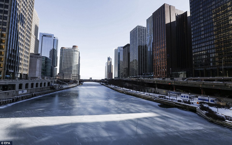 Sheet ice: The frozen Chicago River leading to Lake Michigan is covered in ice as temperatures hover around 12 degrees F (-11 C) in Chicago