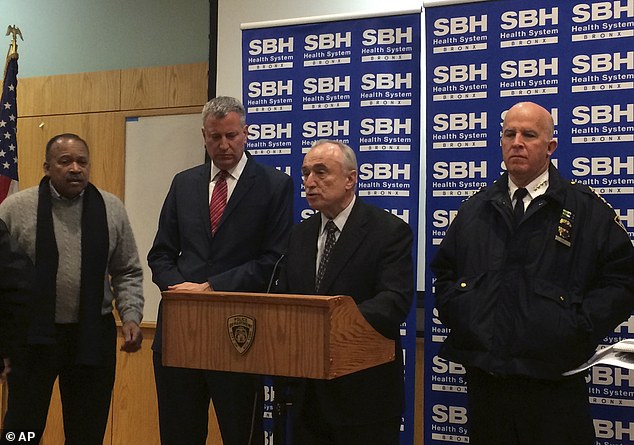 Mayor Bill de Blasio (second from left) and NYPD Commissioner William Bratton (podium) address reporters at St. Barnabas Hospital, where the wounded cops were taken