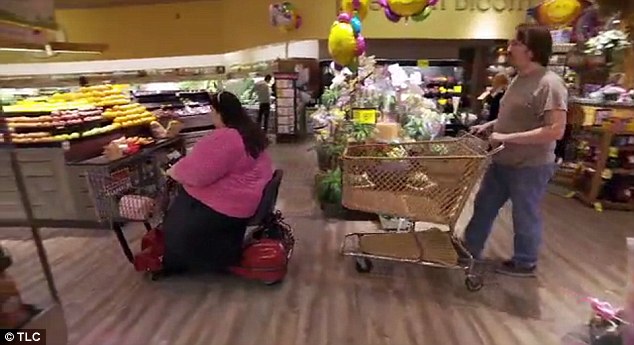 Shopping: The only time Amber (left) leaves the house is to go with Rowdy (right) to buy more food, and to do that she has to cruise the supermarket aisles using a mobility scooter