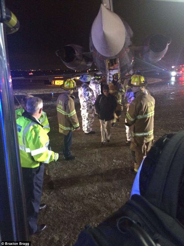 The plane's front nose gear slid on the ice, causing the plane to veer off course. It was unable to continue taxiing to the terminal and the passengers were deplaned through the emergency exit
