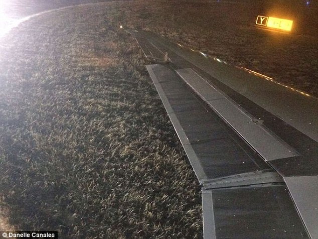 An American Airlines plane landing at Dallas/Forth Worth International airport got stuck in the grass after sliding off a taxiway while attempting to turn a corner on Monday night