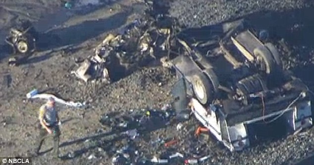 The charred remains of a tractor-trailer which ended upon train tracks in Southern California on Tuesday