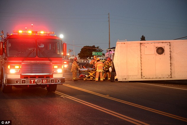 Firefighters attend to injured passengers at the scene of a Metrolink accident on Tuesday morning