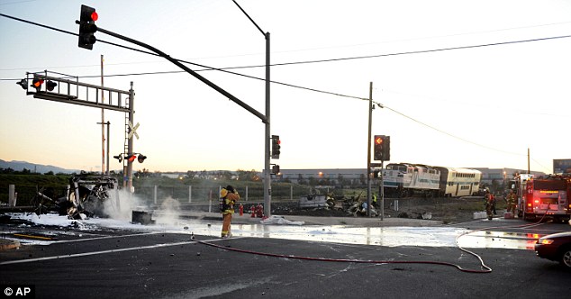 Fire crews fought the blaze at the intersection of train tracks and a highway with water and foam