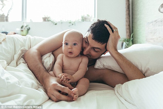 Ernst Berlin (pictured with his nine-month-old son Jacob), from Chicago, has given his wife Agnes a birthday present she will never forget - after commissioning 23 artists to create unique works of art of his family