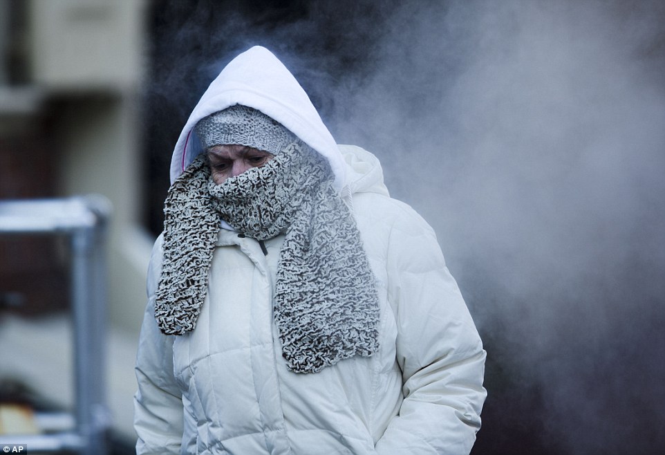 Bitter cold: Commuters across the country had to bundle up against the brutal temperatures. Here, a woman wears a hat, scarf and hood to protect against temperatures in Philadelphia that hit 21 degrees
