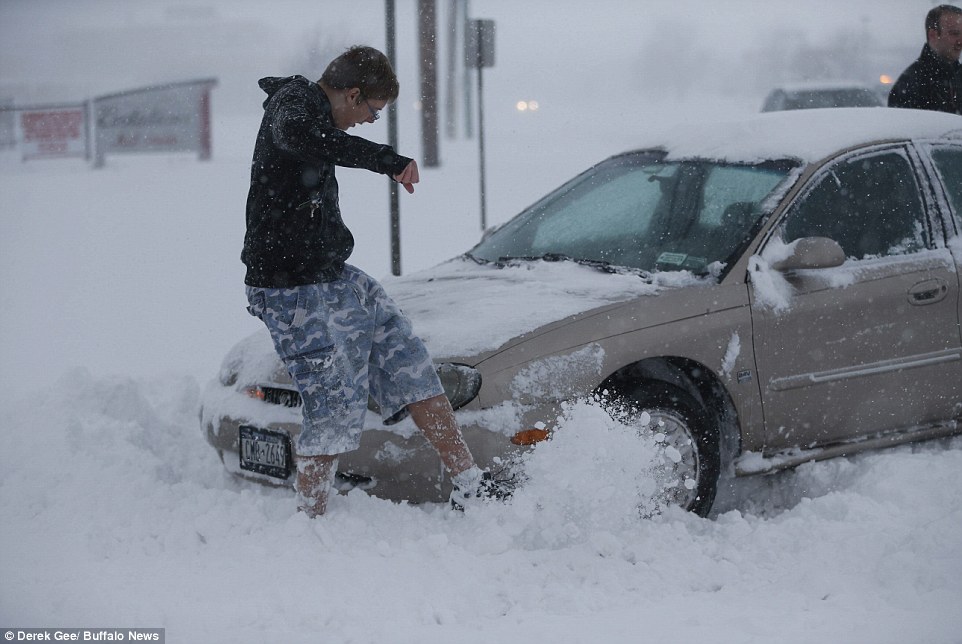 Even in Buffalo, a city that knows snow, the winter pounding took some residents by surprise. A Buffalo News photographer captured this young man wearing shorts while helping a driver dig out