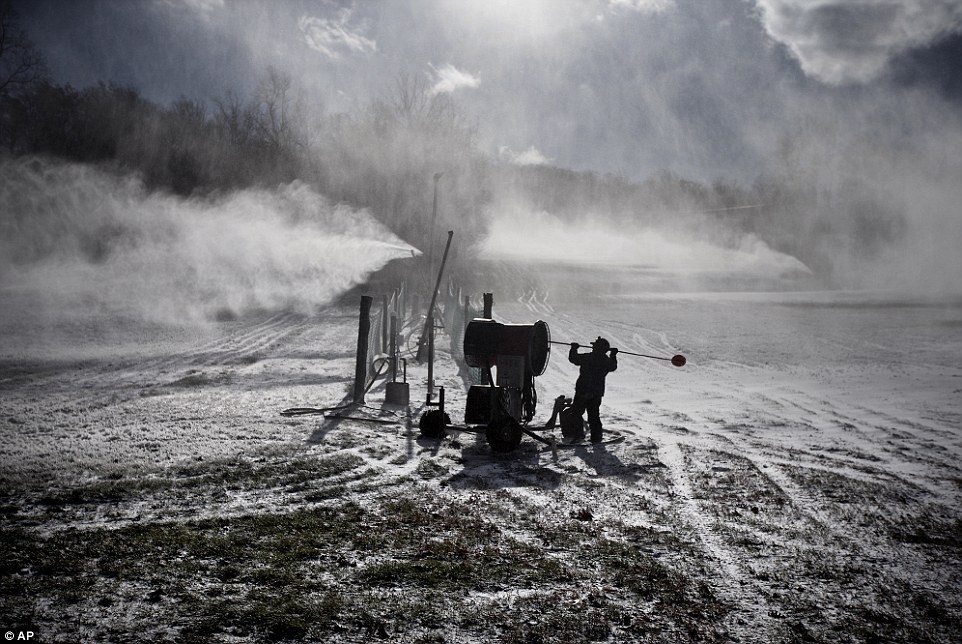 Silver lining? The cold weather is great news for those in the ski industry - pictured are snow cannons getting to work on Roundtop Mountain in Lewisberry, Pennsylvania