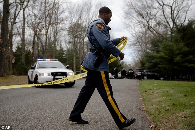 Crime: A police line is secured in Tabernacle, where the four shooting victims were found inside a home 