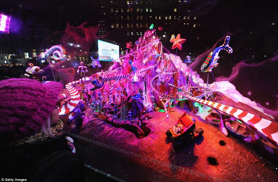 There's a gingerbread planet in this galaxy and one shaped like an ornament. Fido also floats weightless in space. Mars, the red planet, has a glistening mountain that's decked out from top to bottom and friendly little alien inhabitants