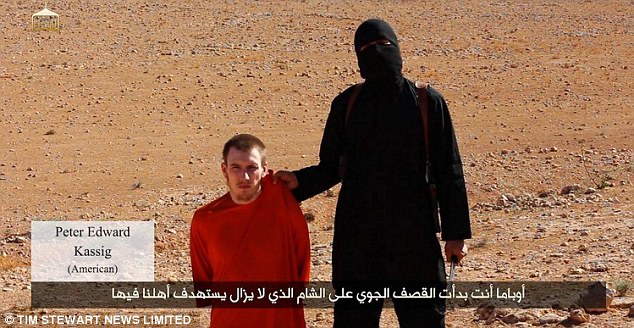 Proof of life: Kassig is pictured here with ISIS executioner Jihadi John, who threatens to behead him in a video for the terror group released earlier this year 