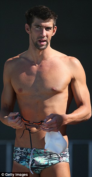 Secrets: Taylor Chandler (left), who claims to be girlfriend to Olympic swimmer Michael Phelps (right) says she was jailed in 1992 for blackmailing a businessman into giving her $10,000 for her corrective surgery