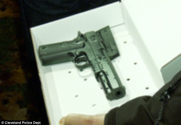 Response: Two Cleveland Police officers arrived at the scene following the 911 call. After the boy refused to put his hands up and reached for the gun (pictured from another perspective), one officer fired at him twice