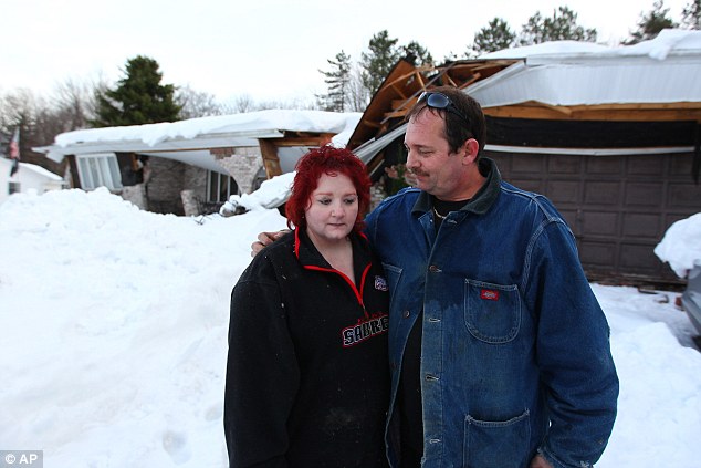 In a state of shock: Risk: More than 775 members of the New York National Guard are currently in Erie county and Buffalo to aid with the snow removal and flood prevention efforts. Above, Tami and Mike Diestler