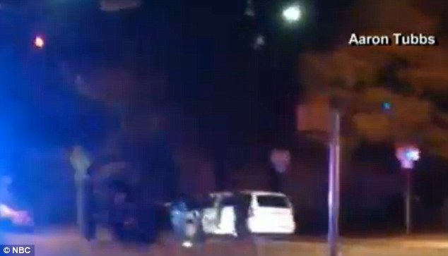 Gunned down: An officer fatally shot the unnamed suspect. This image shows what appears to be cops dragging the man's body away from his van