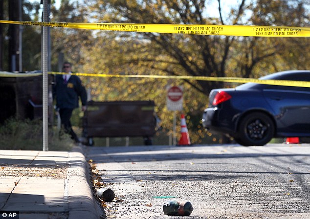 Evidence: Propane tanks the suspect had used to start a fire at the consulate are seen scattered on the ground at the crime scene