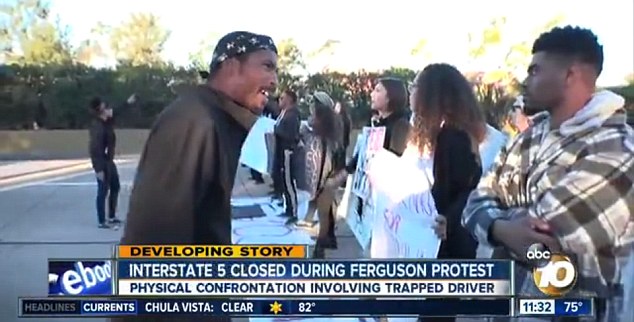 Face-to-face: Mr Landrum, who works three jobs in a bid to provide for his six children, then walked up to the protesters to confront them 