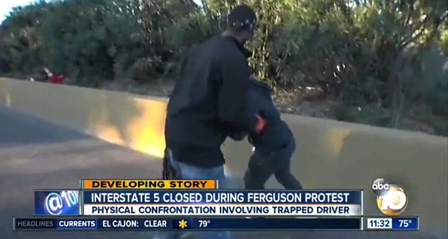 Tussle: At one point, Mr Landrum wrestles the bullhorn from one of the demonstrators 