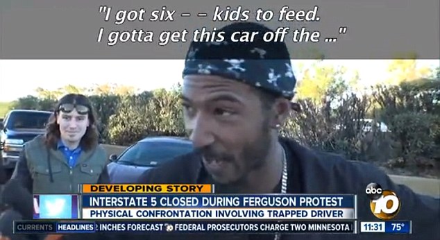 Anger: Father-of-six Tyree Landrum shows his frustration as he arrives at a group of Ferguson protesters on the I-5 in San Diego who are making him late for work 