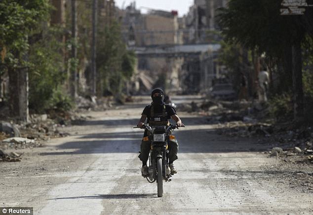 Rebels: Schrier was held by Jabhat al-Nusra; a member is seen riding a motorcycle in Deir al-ZorRead