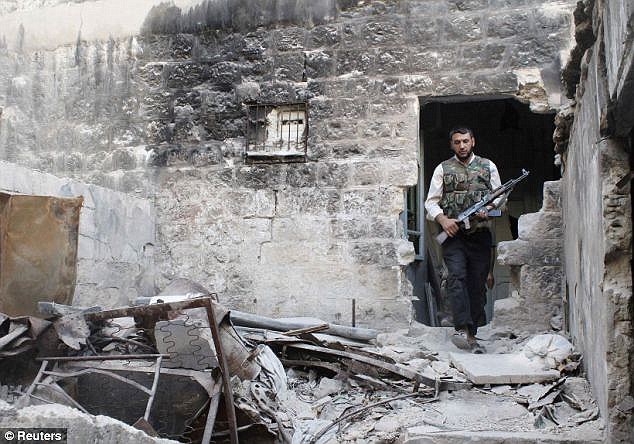 Locked up: The compound where Schier was kept was near Aleppo, where a Free Syrian Army fighter is pictured above