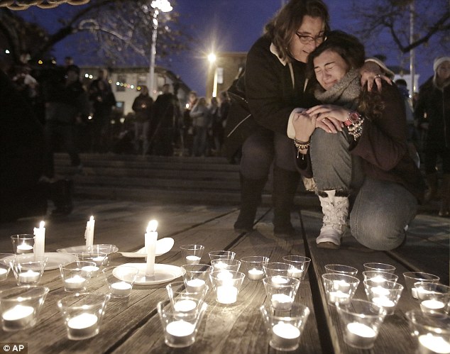 Upset: A woman is comforted by another during a candlelight vigil for Shane Montgomery,at a park across from Kildare's Irish Pub in Manayunk on Saturday
