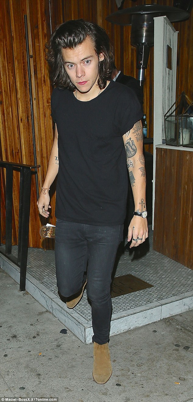 Going solo: Harry is one of the only single 1D boys and is often pictured at clubs without his band mates